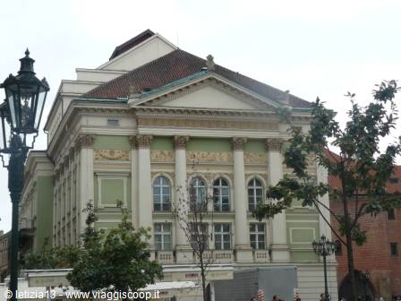Estates Theatre in Prague, green facade with columns and classical pediment