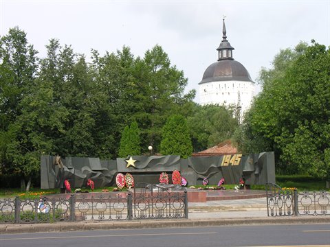 War memorial with star and flower wreaths, behind the white Trinity cathedral in Serpukhov