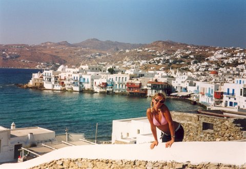 Woman on a white rooftop before Little Venice, Mykonos