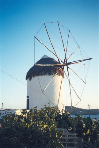 White windmill with thatched roof and wooden sails in Mykonos
