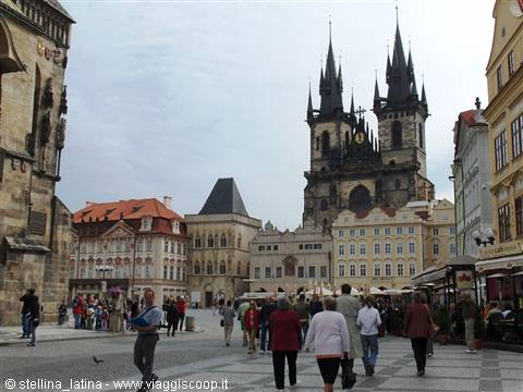 in the Old Town square the gothic of the Church of Tyn stands out