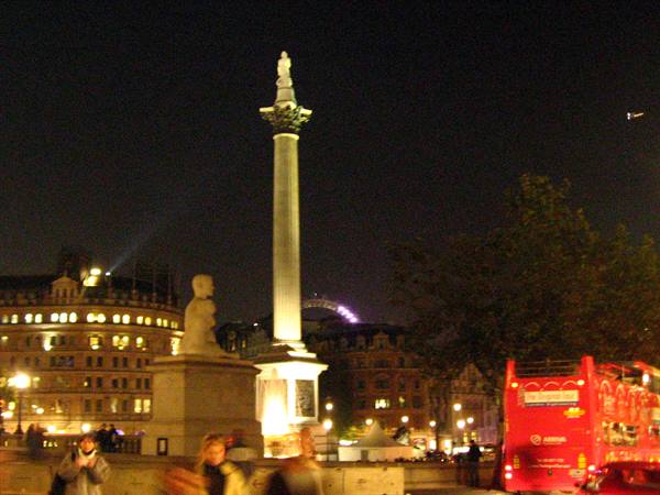 Nelson's Column at night in Trafalgar Square, red bus and London Eye