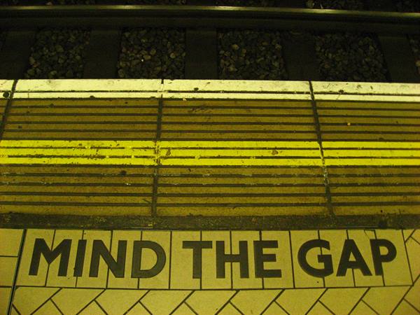 Mind the gap warning painted on the yellow edge of the Underground platform