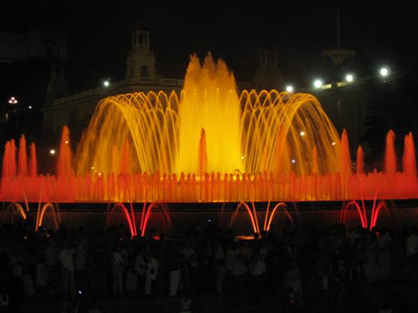 Magic Fountain of Montjuïc in Barcelona, water jets lit in yellow and red