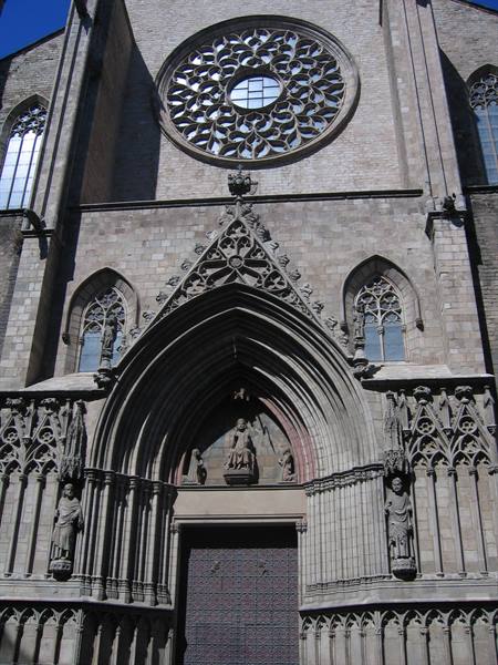 Gothic facade of Santa Maria del Mar in Barcelona, stone rose window and carved portal
