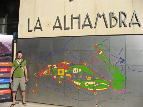Tourist standing before the metal map of the Alhambra in Granada