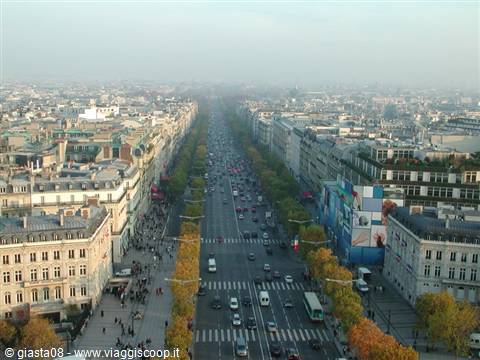 Champs-Élysées avenue seen from the Arc de Triomphe, traffic and Parisian rooftops in haze