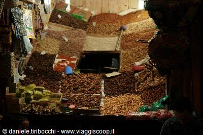 Stalls piled with dates, nuts and spices in Marrakech medina market