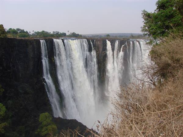 Victoria Falls: Zambezi water plunging over dark rocks into white mist