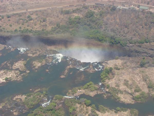 Victoria Falls from above: mist rising over the gorge with rainbow, Zambezi River