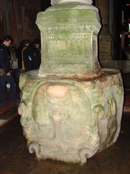 Column base with upside-down Medusa head, Basilica Cistern, visitors beside