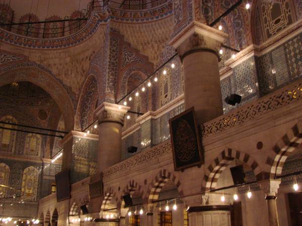 Interior of Yeni Cami in Istanbul, columns, ceramic tiles and lit bulbs