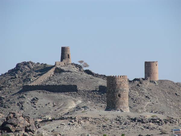 Ancient stone and mud defensive towers on rocky desert hill