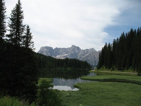 Lake Misurina still water between firs and Dolomite peaks