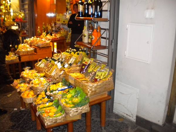 Wicker baskets of limoncello bottles displayed outside a shop