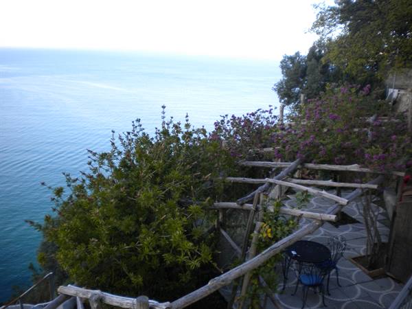 Wooden terrace with bougainvillea over the sea, Positano