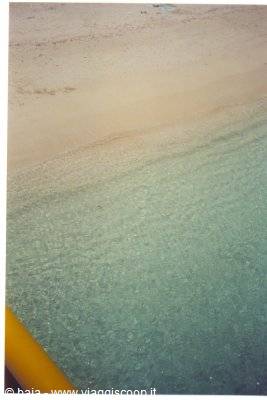 Turquoise water and light sand seen from the boat
