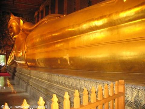 Large reclining golden Buddha statue inside Wat Pho temple, Bangkok