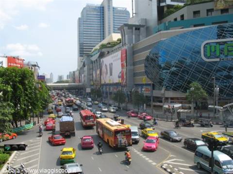 Heavy traffic with buses and taxis in front of MBK shopping mall, Bangkok