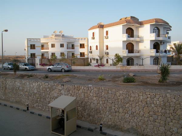 a security post and buildings beyond the resort