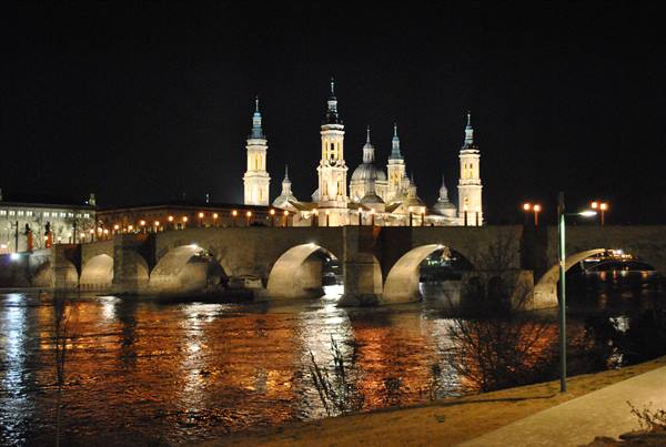 Stone Bridge and Basilica del Pilar lit up over the Ebro at night