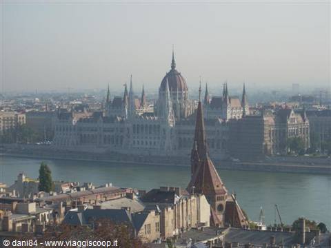 Budapest Parliament across the Danube in the haze, city rooftops below