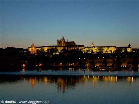 Prague, lit-up Castle and Charles Bridge reflected in the Vltava at night