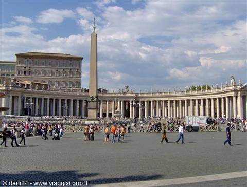 Egyptian obelisk and Bernini colonnade in St. Peter's Square, tourists walking