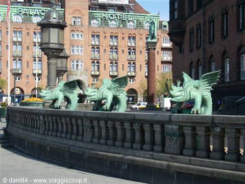 Green bronze dragons on a stone parapet at Copenhagen City Hall