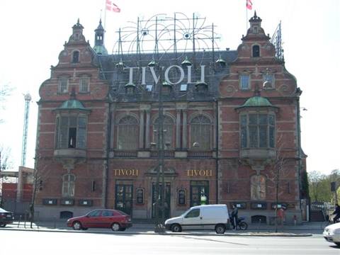 Red brick facade of Copenhagen's Tivoli with flags and cars