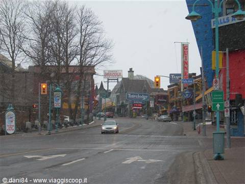Clifton Hill in Niagara Falls, car stopped at traffic light in the rain