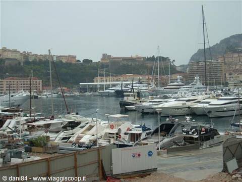 Monaco harbor crowded with yachts and boats under a gray sky