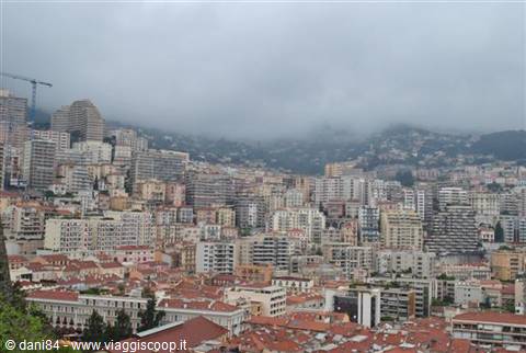 Monaco high-rises and red rooftops wrapped in low clouds