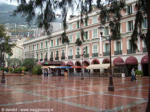 Casino Square in Monte Carlo, rain-soaked pavement, cafés with red awnings