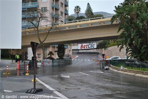Monte Carlo circuit: yellow overpass above wet street lined with race barriers