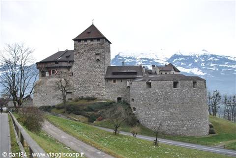 Vaduz Castle stone fortress with snowy mountains in the background