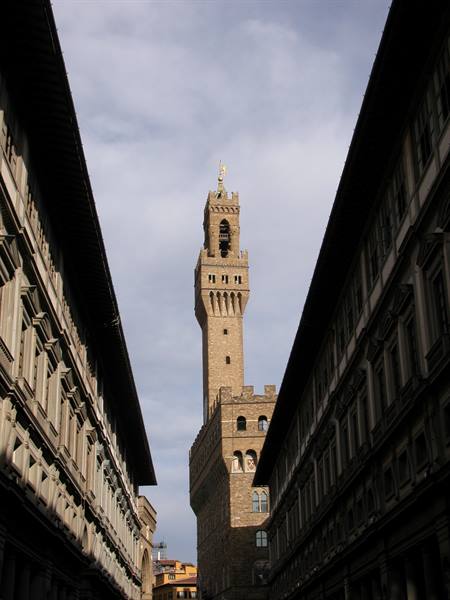 Palazzo Vecchio tower in Florence framed by the Uffizi stone corridors