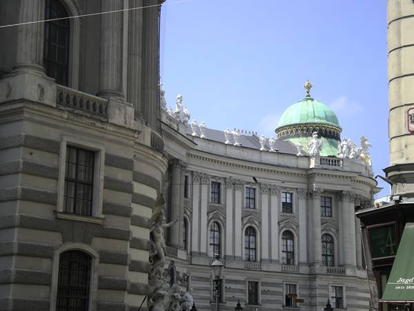 Baroque Hofburg facade in Vienna with green dome and statues