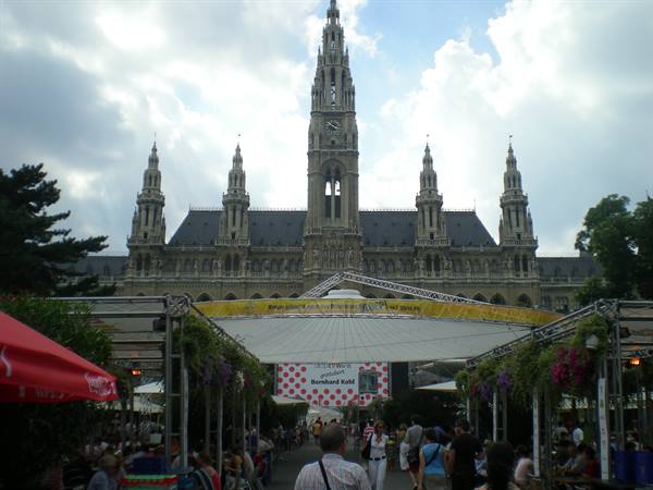 Visitors under tents and umbrellas in front of Vienna's neo-Gothic Rathaus