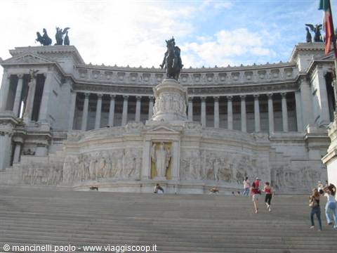 Tourists climb the steps of the Vittoriano in Rome, white marble monument with equestrian statue
