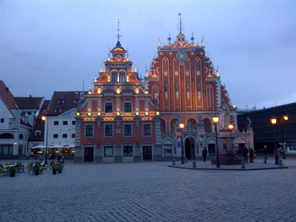 House of the Blackheads lit at dusk on Riga's cobblestone square