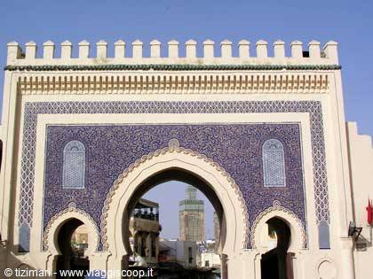 Bab Bou Jeloud gate in Fez, blue zellige tiles, minaret visible through the arch