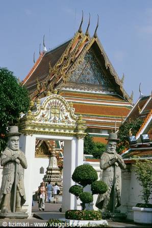 Stone guardian statues at Wat Pho temple gate, Bangkok