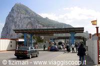 Cars at the border checkpoint beneath the Rock of Gibraltar, blue sky