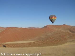 Colorful hot air balloon above the red dunes of Sossusvlei