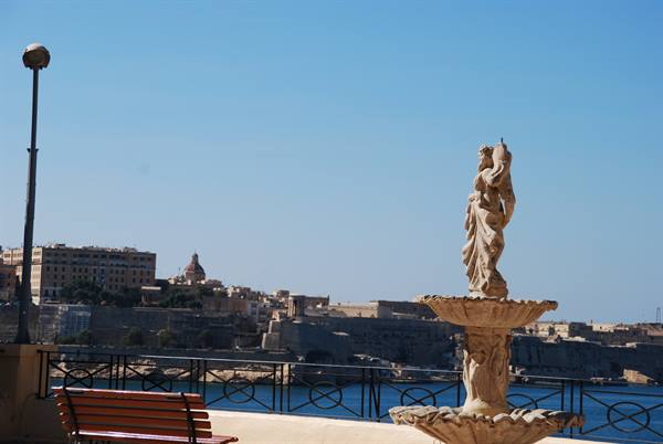 Stone fountain with statue on the terrace overlooking Valletta harbour