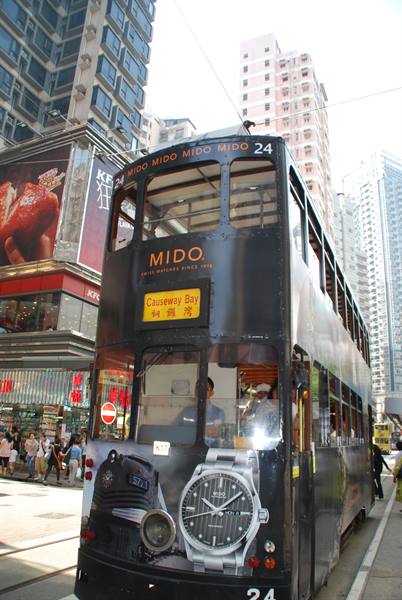Double-decker tram with MIDO ads among skyscrapers, Causeway Bay, Hong Kong