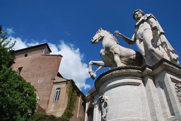Marble statue of the Dioscuri with horse, Campidoglio, Rome, against blue sky
