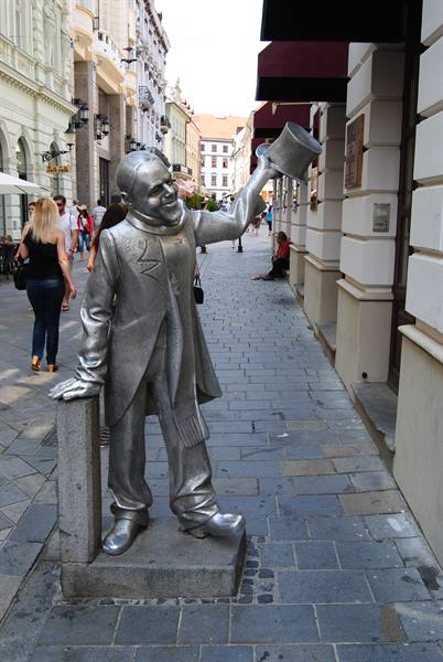 Metal statue of the top-hat greeter waves along Bratislava's pedestrian street