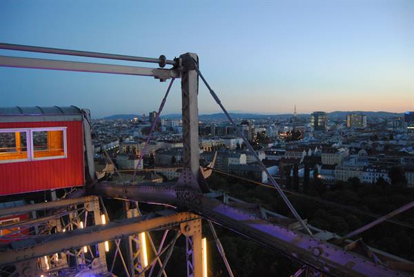 Red cabin of the Prater Ferris wheel over Vienna at dusk